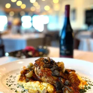 a plate of food and a bottle of wine