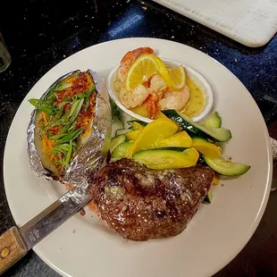 Shrimp and steak combo. Shrimp scampi as the side pairing with a loaded potato and sautéed zucchini.