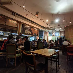 people sitting at tables in a restaurant