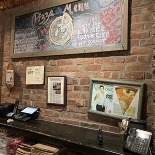 a brick wall with a sign that says pizza grill