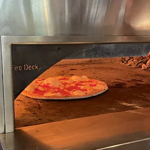 a pizza cooking in an oven