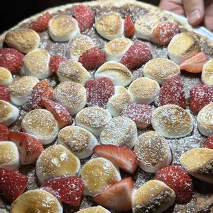 a pancake with strawberries, bananas, and marshmallows