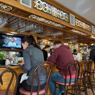 a group of people sitting at a bar