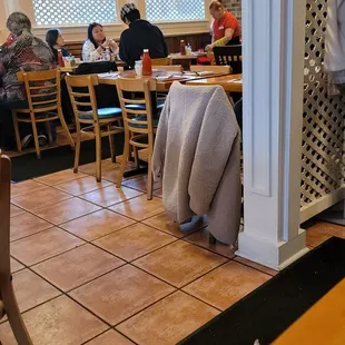 people sitting at tables in a restaurant