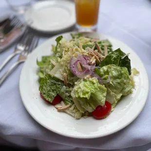 a white plate with a salad on it