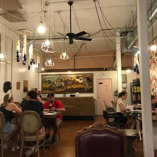people sitting at tables in a restaurant
