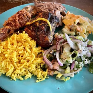 Roast chicken surrounded by rice, fried chicken, brisket, pasta salad, and Mediterranean salad. Each of these items was delicious!