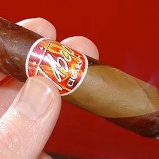 a hand holding a cigar