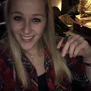 a woman holding a cigar