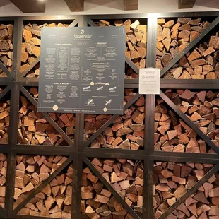 a large pile of firewood in a warehouse