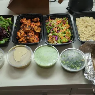 Family meal with chicken and side of tabouli