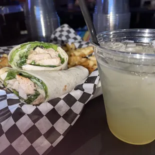 Grilled chicken Caesar wrap with waffles fries.  Pineapple Tito&apos;s.