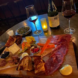 a table with a variety of food and wine