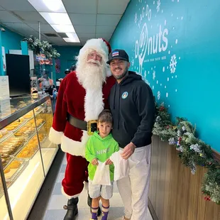 a man in a santa suit with a little boy