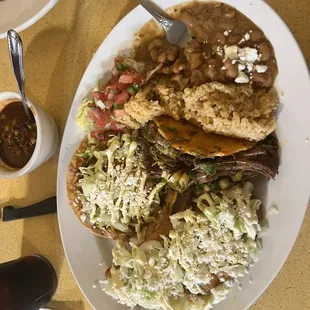 A combo plate - made up by recommendation of Kenny (wait staff) - with a Tostada, an enchilada and the Birria Taco.