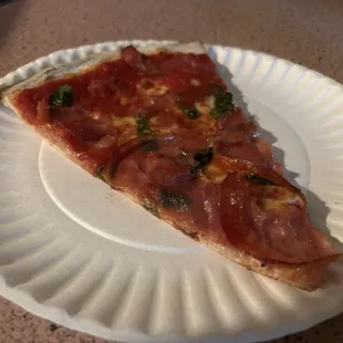 Regular pizza with prosciutto and basil