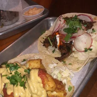 two tacoss on a tray