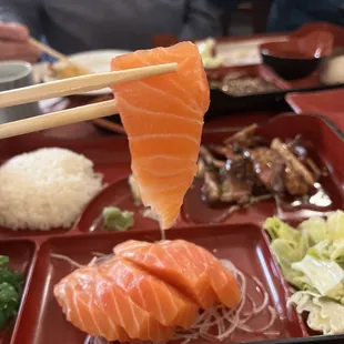 Lots of salmon sashimi in dinner bento box