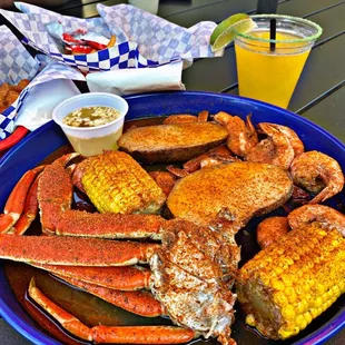 a plate of crab legs and corn on the cob