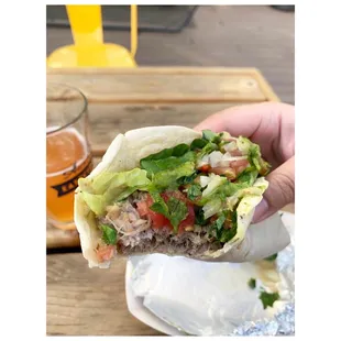 a hand holding a burrito