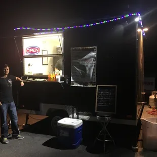 a man standing in front of a food truck
