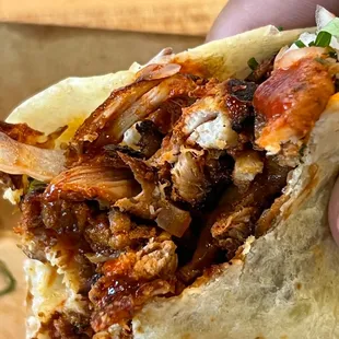 a hand holding a sandwich