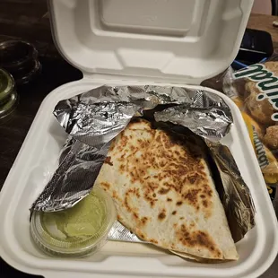 a burrito in a styrofoam container