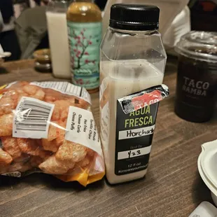 a bottle of milk and a bag of fried chicken