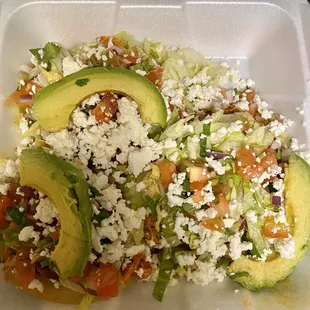 An order of Pollo Sopes (chicken) lodes with yummy toppings!