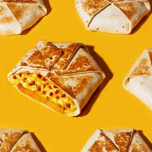 a table with a box of wraps and a cup of coffee