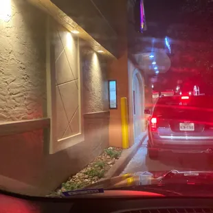 a view of a taco bell from inside a car