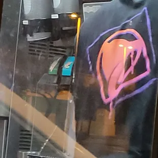 a man wearing a t - shirt with a neon heart on it