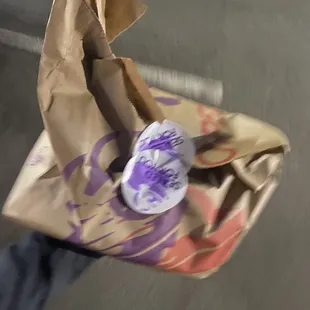 a person holding a bag of food