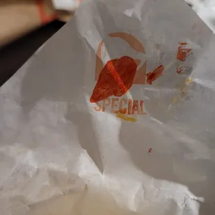 As im unwrapping one of my tacos, i come across this on one of the wrappers. In 100% looks like blood. How disgusting! Whats going on!