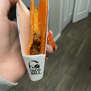 a hand holding a taco bell