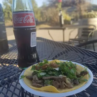 The traditional Mexican lunch, a taco and a coke.