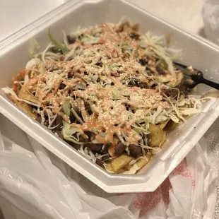 Asada tajadas. Steak, cotija cheese, shredded cabbage over fried plantains.