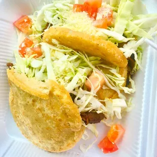 two tacos on a white plate