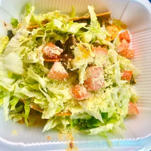 a salad in a styrofoam container