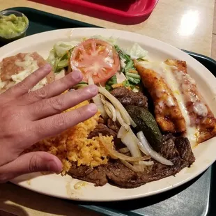 Tampiqueña. DELICIOUS! My hand over it is to give you a better idea of the sheer size of this dish.