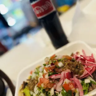 a plate of food and a bottle of coke