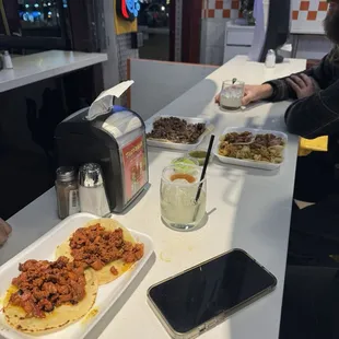 a man sitting at a table with plates of food