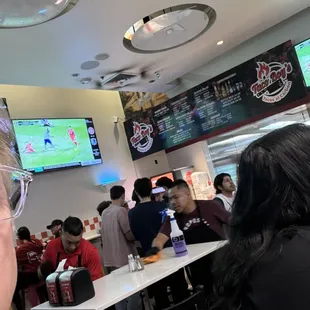 a group of people sitting at tables in a restaurant