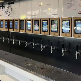 Line of self-serve beer taps