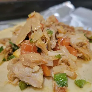 chicken and vegetables on a tortilla