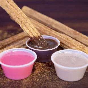 Churros with chocolate, strawberry, and horchata dipping sauce