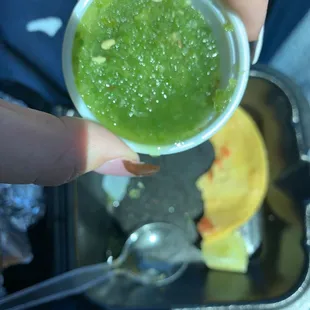 a person holding a bowl of salsa