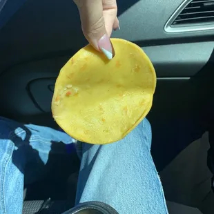 a person holding a piece of food