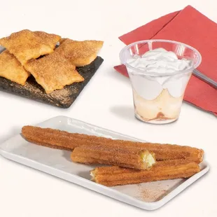 a plate of churros and a glass of yogurt