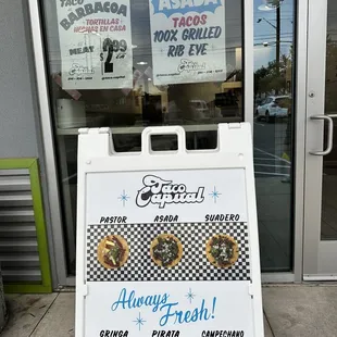 a sign in front of a restaurant